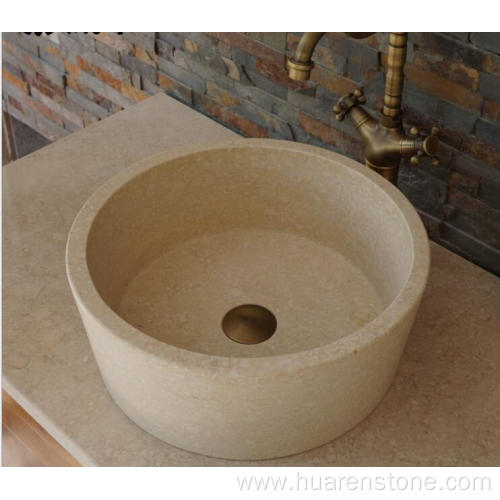 Round beige travertine sink